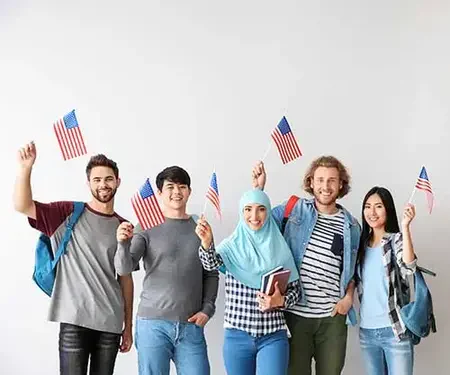 Diverse group of five waving small American flags.